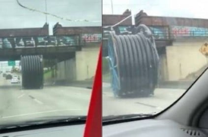 Huge spool rolling down road disrupts traffic - watch video